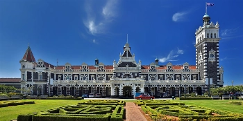 2027 New Zealand & Australia Golf Cruise Vacation Package Railway Station of Dunedin, New Zealand - PerryGolf + Azamara Cruises